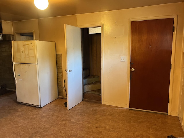 unfurnished bedroom with freestanding refrigerator