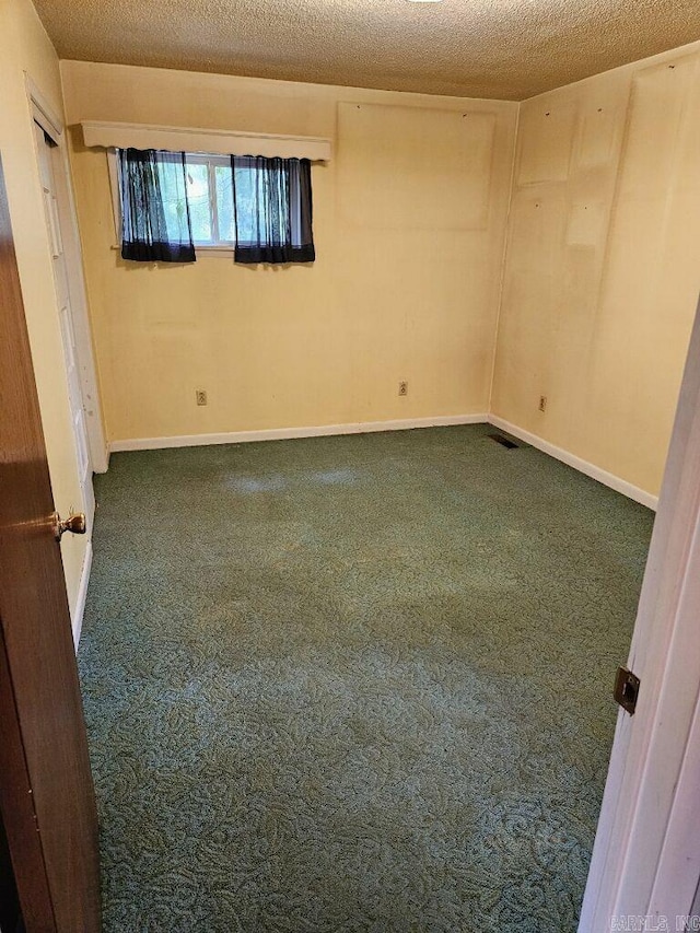 unfurnished room featuring carpet floors and baseboards