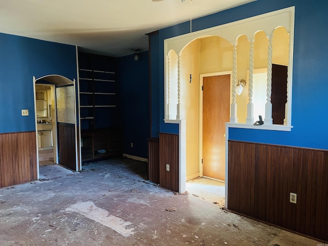 spare room featuring wainscoting