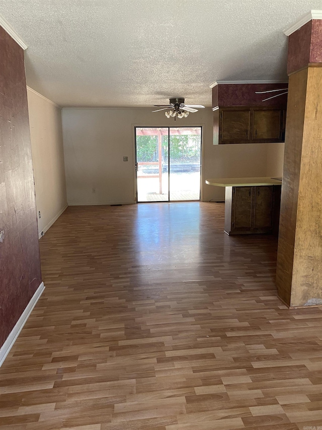 interior space with a textured ceiling, light wood-type flooring, and ceiling fan