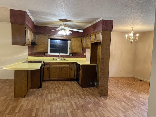 kitchen featuring light countertops, light wood-style flooring, ornamental molding, and a sink