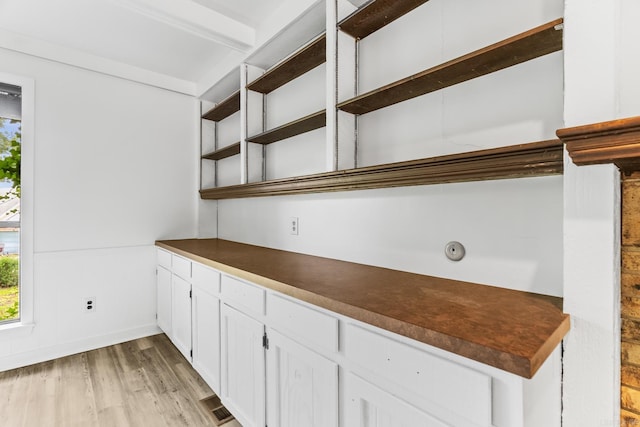 kitchen with light hardwood / wood-style floors and white cabinetry