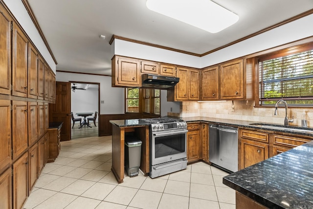 kitchen featuring dark stone counters, a wealth of natural light, kitchen peninsula, and stainless steel appliances