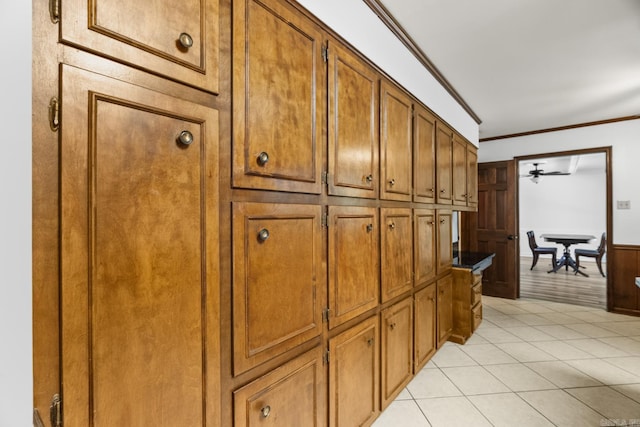 corridor with crown molding and light tile patterned flooring