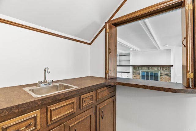 kitchen featuring a brick fireplace and sink