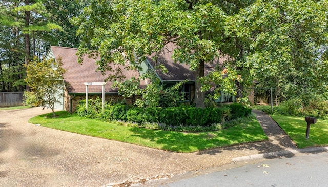 exterior space featuring a garage and a front lawn