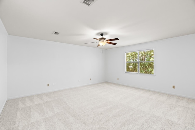 carpeted empty room featuring crown molding and ceiling fan