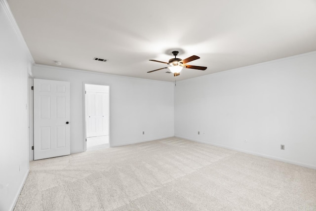 unfurnished room featuring crown molding, light colored carpet, and ceiling fan