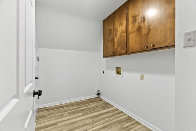 laundry room featuring cabinets, electric dryer hookup, washer hookup, and hardwood / wood-style flooring