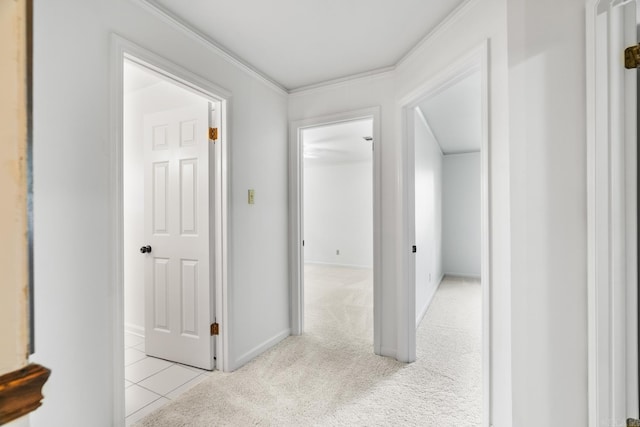 corridor with ornamental molding and light carpet