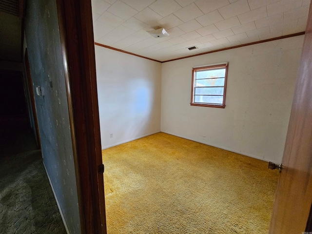 unfurnished room featuring carpet flooring and ornamental molding