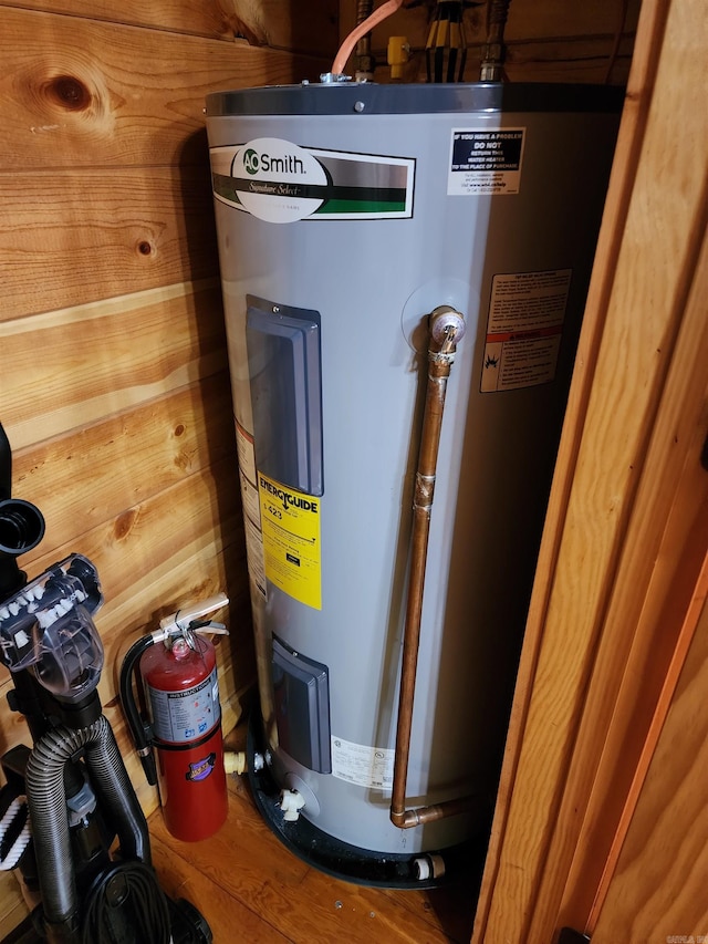 utility room with electric water heater