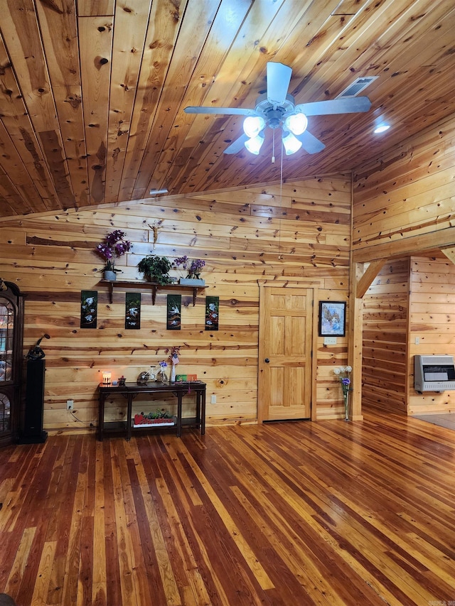 unfurnished living room featuring wood ceiling, hardwood / wood-style flooring, lofted ceiling, ceiling fan, and wooden walls