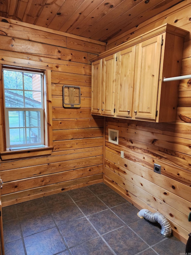 washroom featuring wood walls, wood ceiling, cabinets, and electric dryer hookup