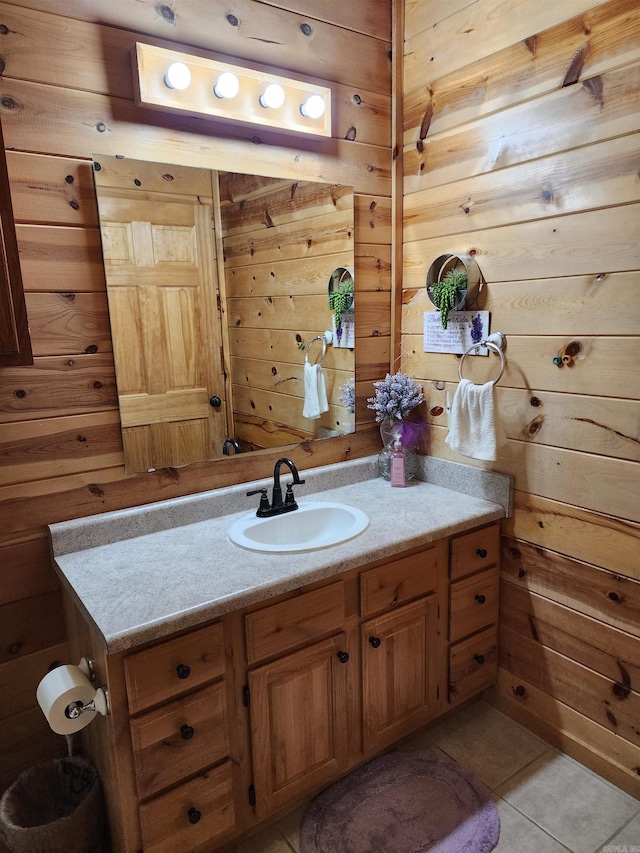 bathroom featuring wood walls, tile patterned flooring, and vanity