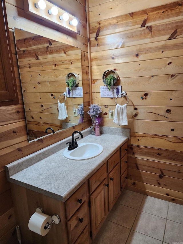 bathroom with vanity, wood walls, and tile patterned flooring