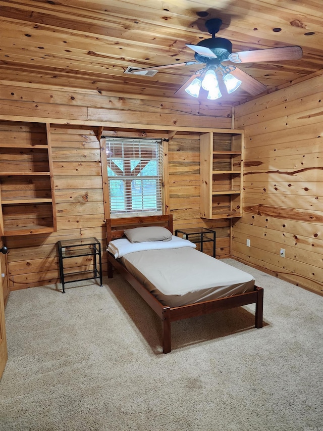 bedroom featuring wood ceiling, wood walls, ceiling fan, and carpet floors