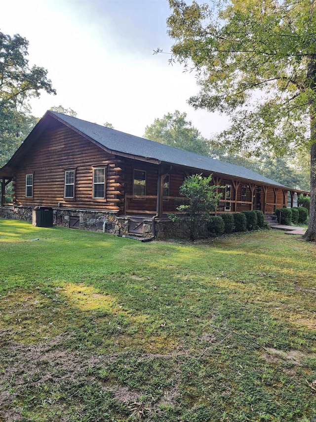 view of front of property with central air condition unit and a front lawn