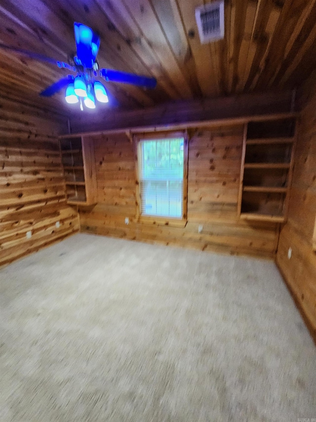 basement featuring carpet flooring, wooden walls, and wooden ceiling