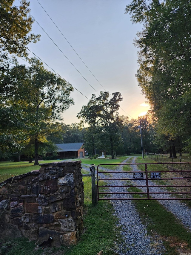 gate at dusk with a yard