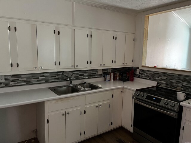 kitchen with white cabinets, backsplash, sink, range with electric stovetop, and a textured ceiling