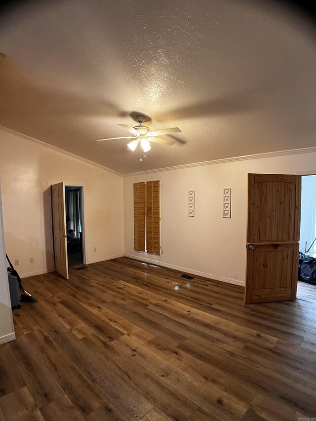 unfurnished bedroom featuring ceiling fan, dark hardwood / wood-style flooring, crown molding, and a textured ceiling