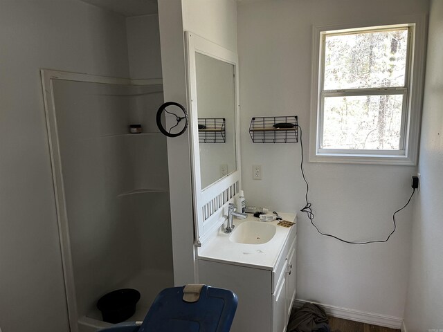 bathroom featuring vanity and a shower