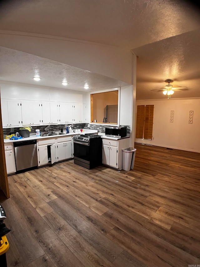 kitchen featuring white cabinetry, appliances with stainless steel finishes, dark hardwood / wood-style flooring, and ceiling fan