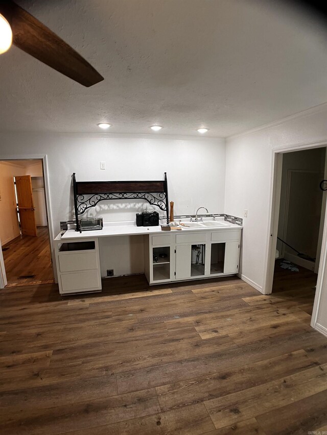 unfurnished bedroom with a textured ceiling and wood-type flooring