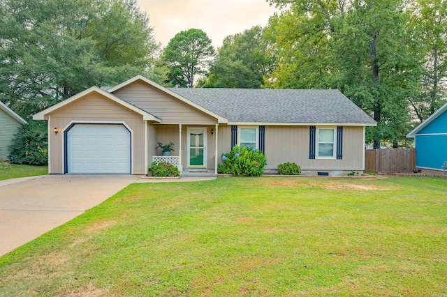 ranch-style house featuring a yard and a garage