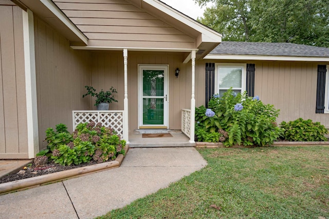 view of exterior entry featuring a yard