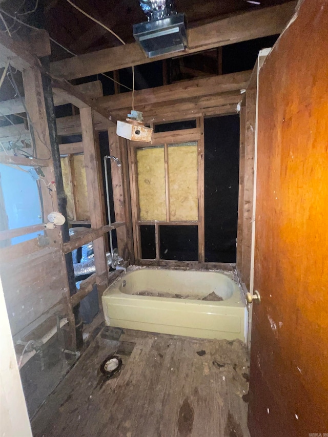 bathroom with wood-type flooring and a bathing tub