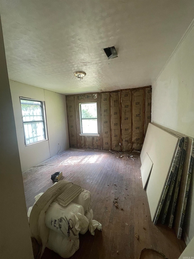 interior space with hardwood / wood-style flooring and a textured ceiling