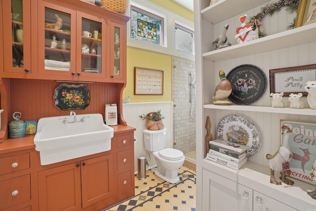 bathroom featuring walk in shower, toilet, and vanity