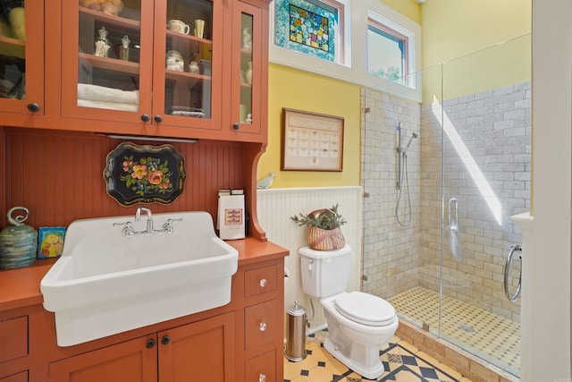 bathroom featuring vanity, toilet, tile patterned floors, and walk in shower