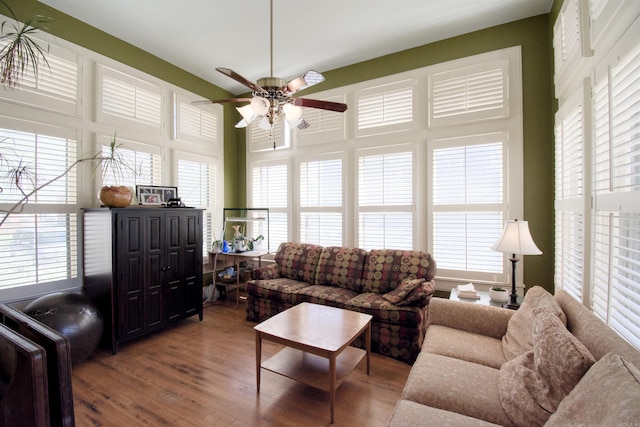 living room featuring a wealth of natural light, ceiling fan, and wood-type flooring