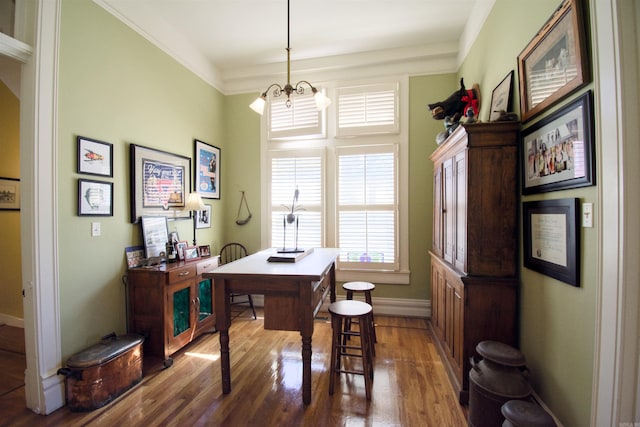 office featuring dark hardwood / wood-style floors, an inviting chandelier, and crown molding