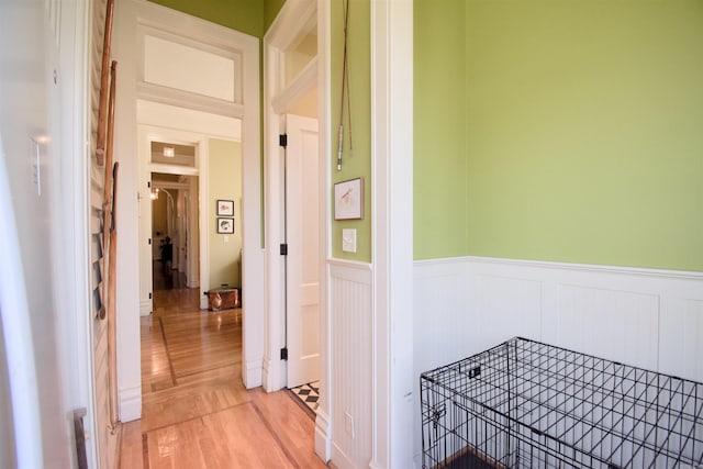 hallway with light hardwood / wood-style floors