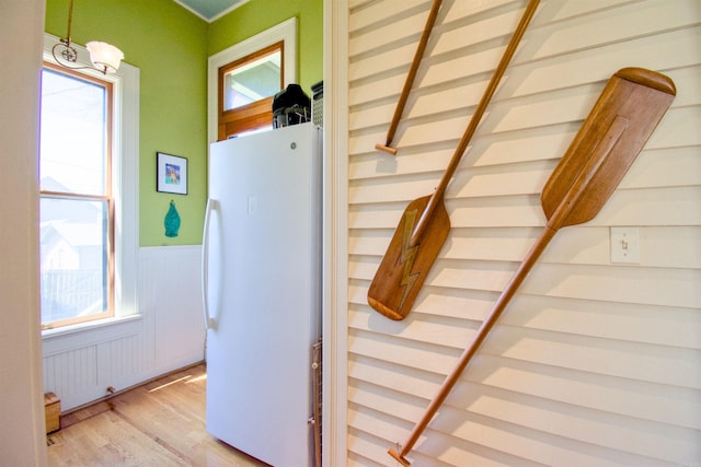 interior details featuring white fridge and wood-type flooring