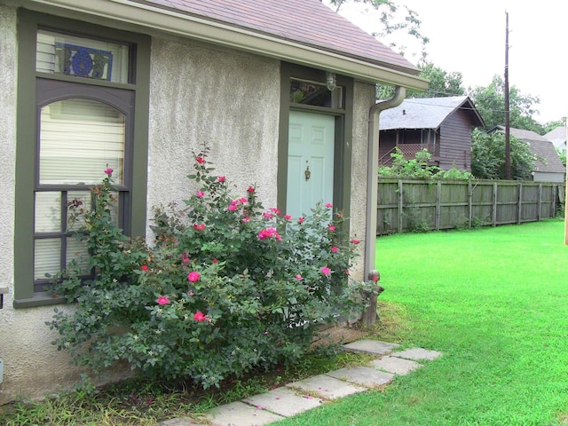 property entrance with a yard