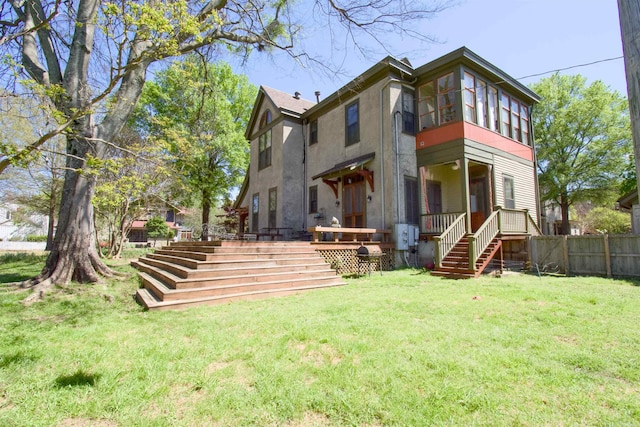 rear view of house with a yard