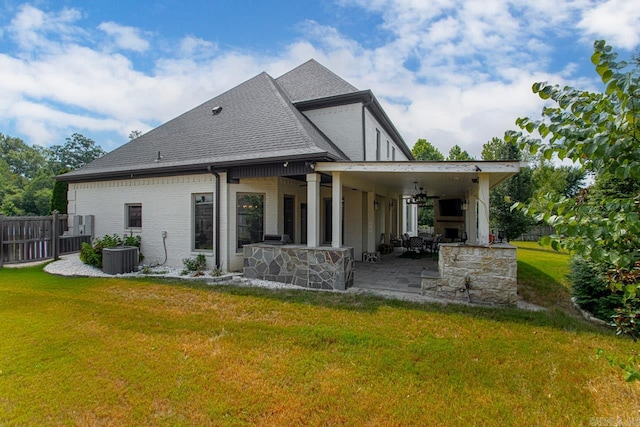 rear view of house featuring a yard, ceiling fan, a patio, and central AC