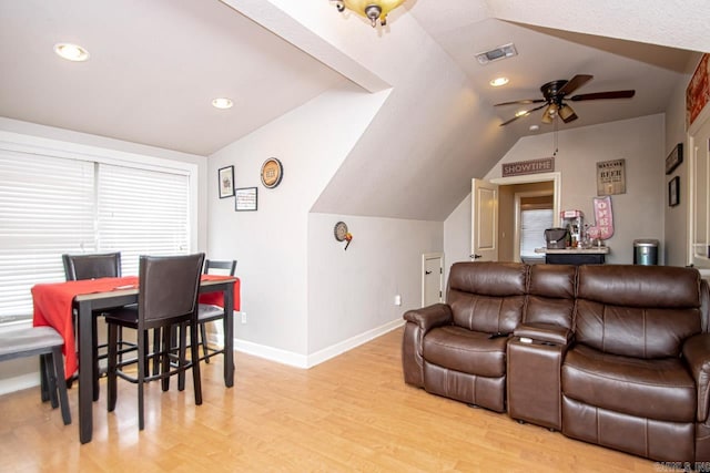 home theater room with vaulted ceiling, ceiling fan, and light hardwood / wood-style floors