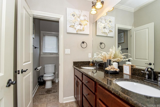 bathroom with ornamental molding, vanity, toilet, and tile patterned flooring