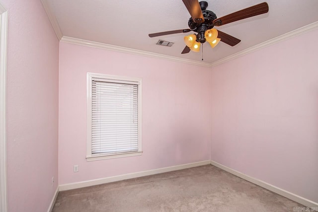 empty room with crown molding, ceiling fan, and carpet floors