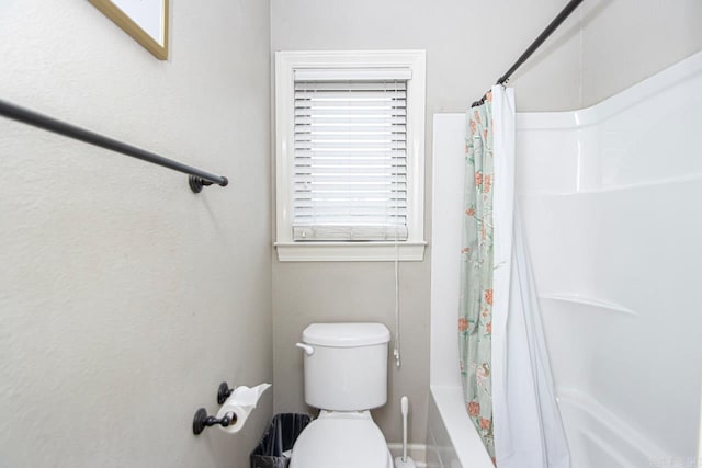 bathroom with toilet and shower / tub combo