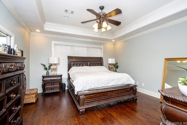 bedroom with ornamental molding, a tray ceiling, ceiling fan, and dark hardwood / wood-style floors