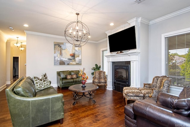 living room featuring ornamental molding, dark hardwood / wood-style flooring, a chandelier, and a tile fireplace