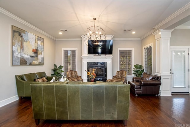 living room featuring dark wood-type flooring, an inviting chandelier, and ornamental molding