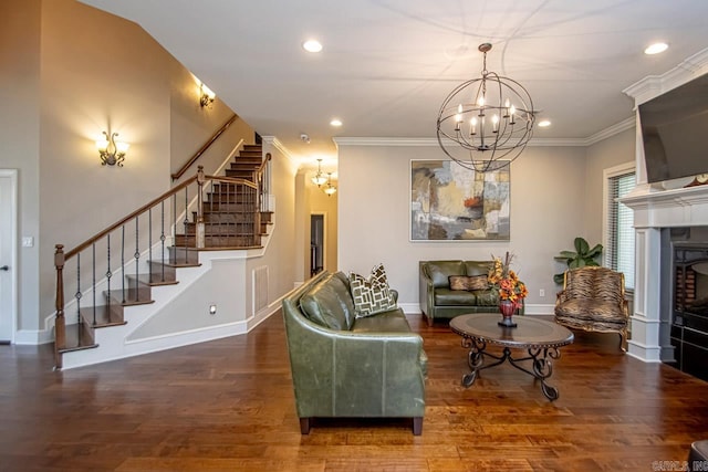 living room featuring dark wood-type flooring, a notable chandelier, and ornamental molding